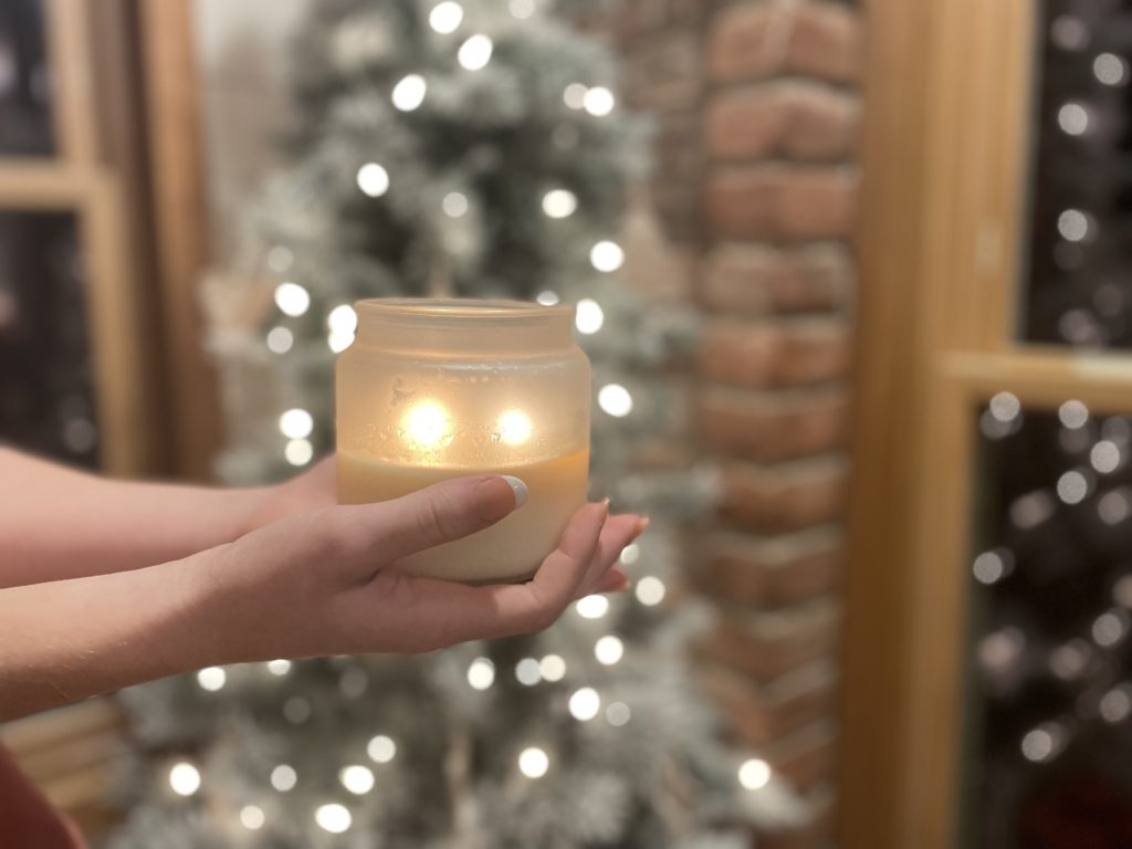 Lighted soy candle in frosted jar