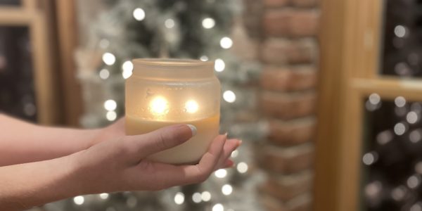 Lighted soy candle in frosted jar